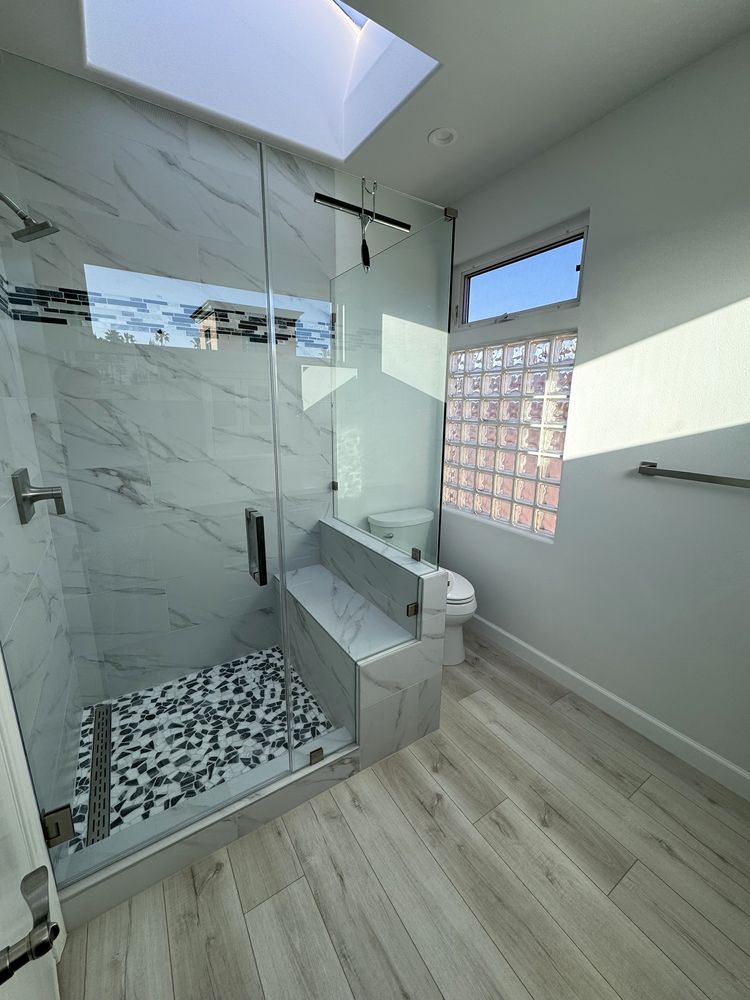 Walk-in shower with bench and frameless glass